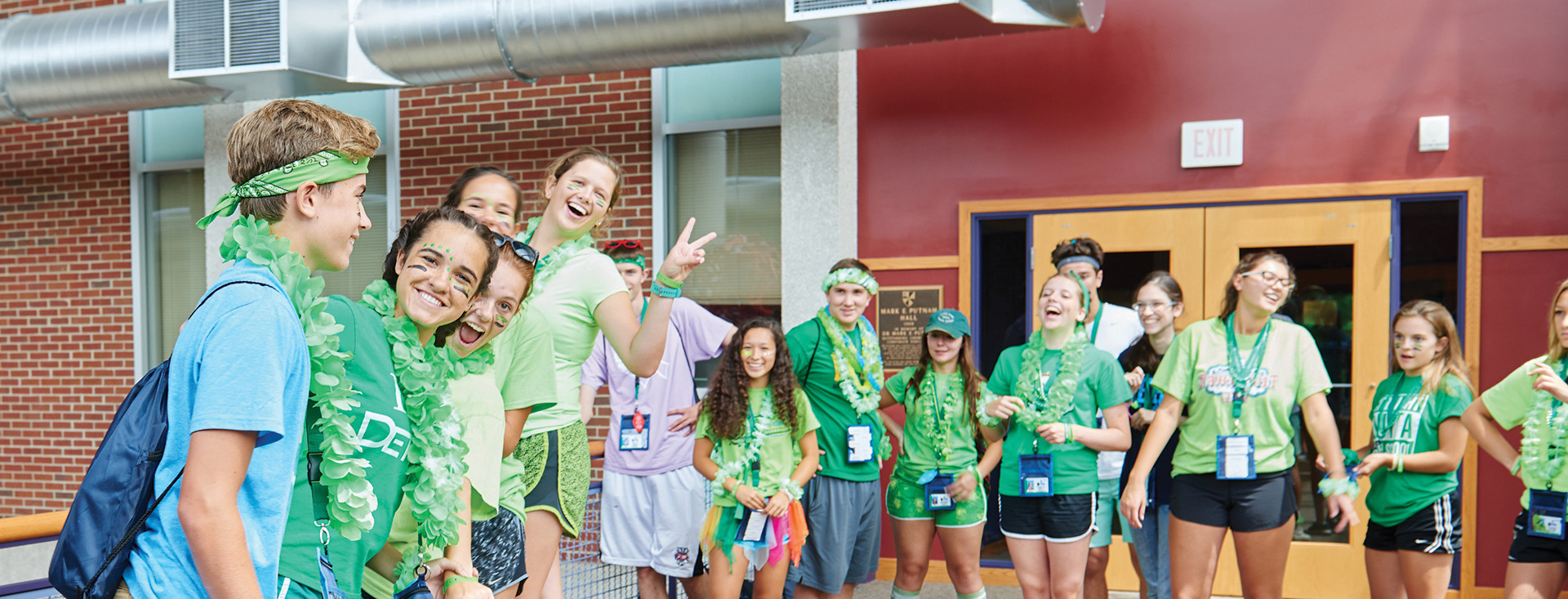 students wearing green smiling